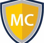 A graphic of a yellow and silver shield with the letters M and C in white in the centre.