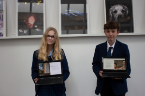 Caitlin from Year 7 and Ruben from Year 8 pose for a photo with their laptops after completing the 200 Word Adobe SPARK Challenge.