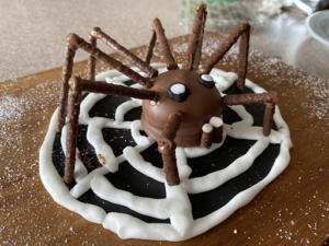 A Tea Cake decorated in the shape of a big Spider.