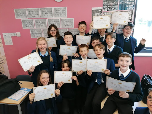 Members of the Young Writers Club at Mascalls Academy are seen showing off their certificates to the camera.