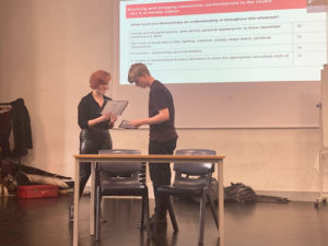 Two students are seen rehearsing their lines in a Drama lesson.