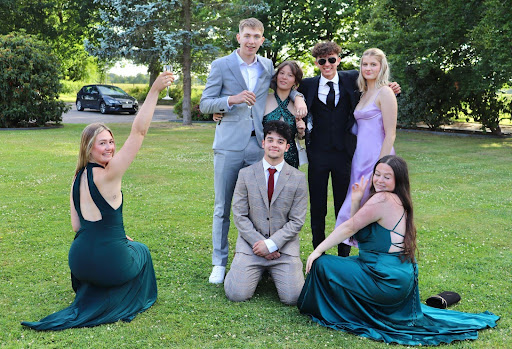 Seven Year 13 students are shown dressed up together for their Prom night.