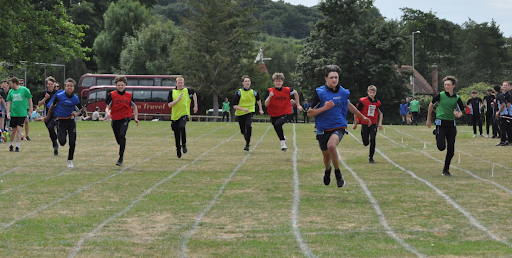 Students are seen running in lanes for a race on Sports Day.