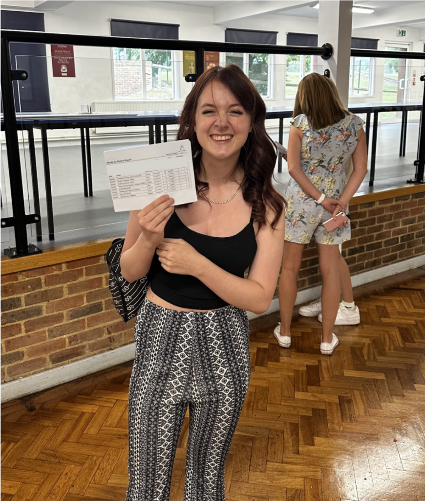 Student holding their results