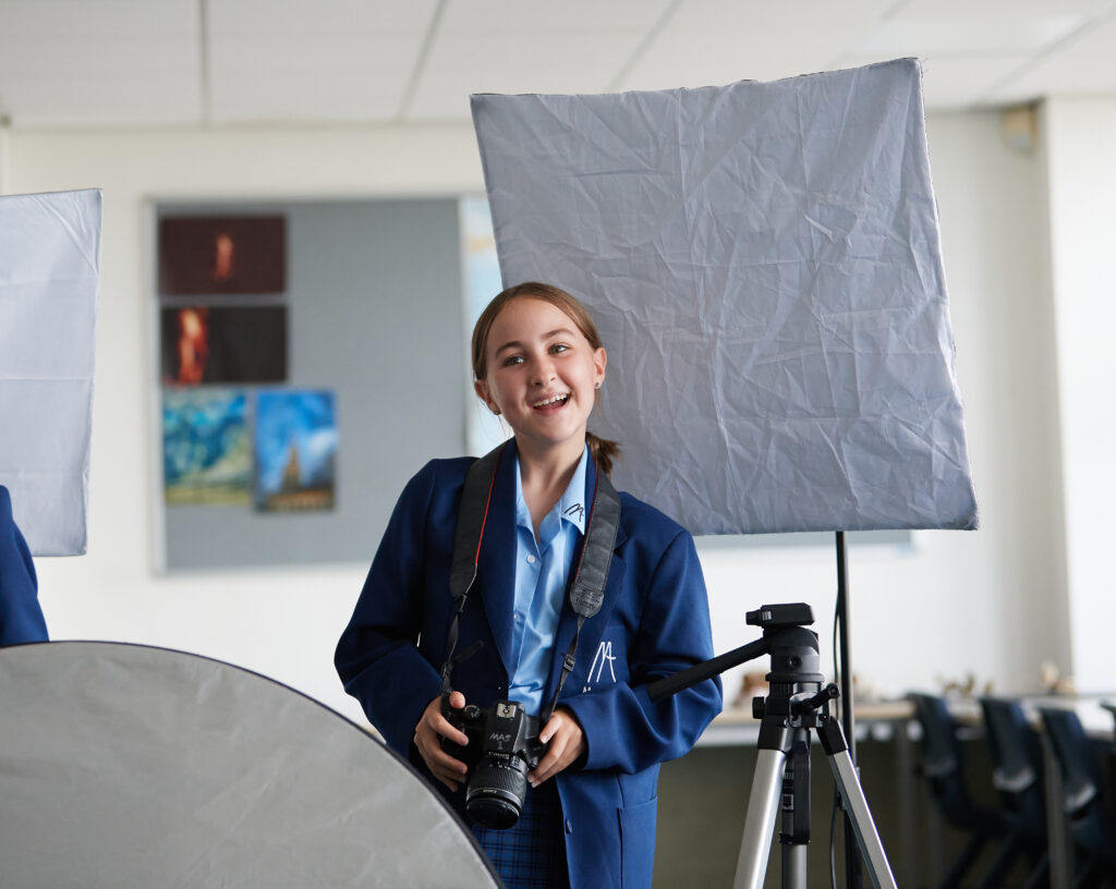 Student holding a camera
